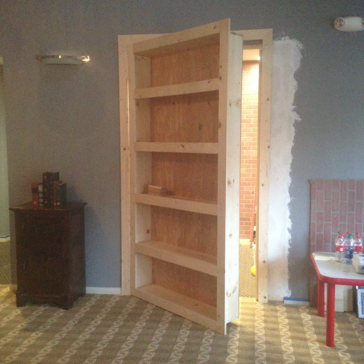 artist brandon roth builds a hidden room behind a bookcase